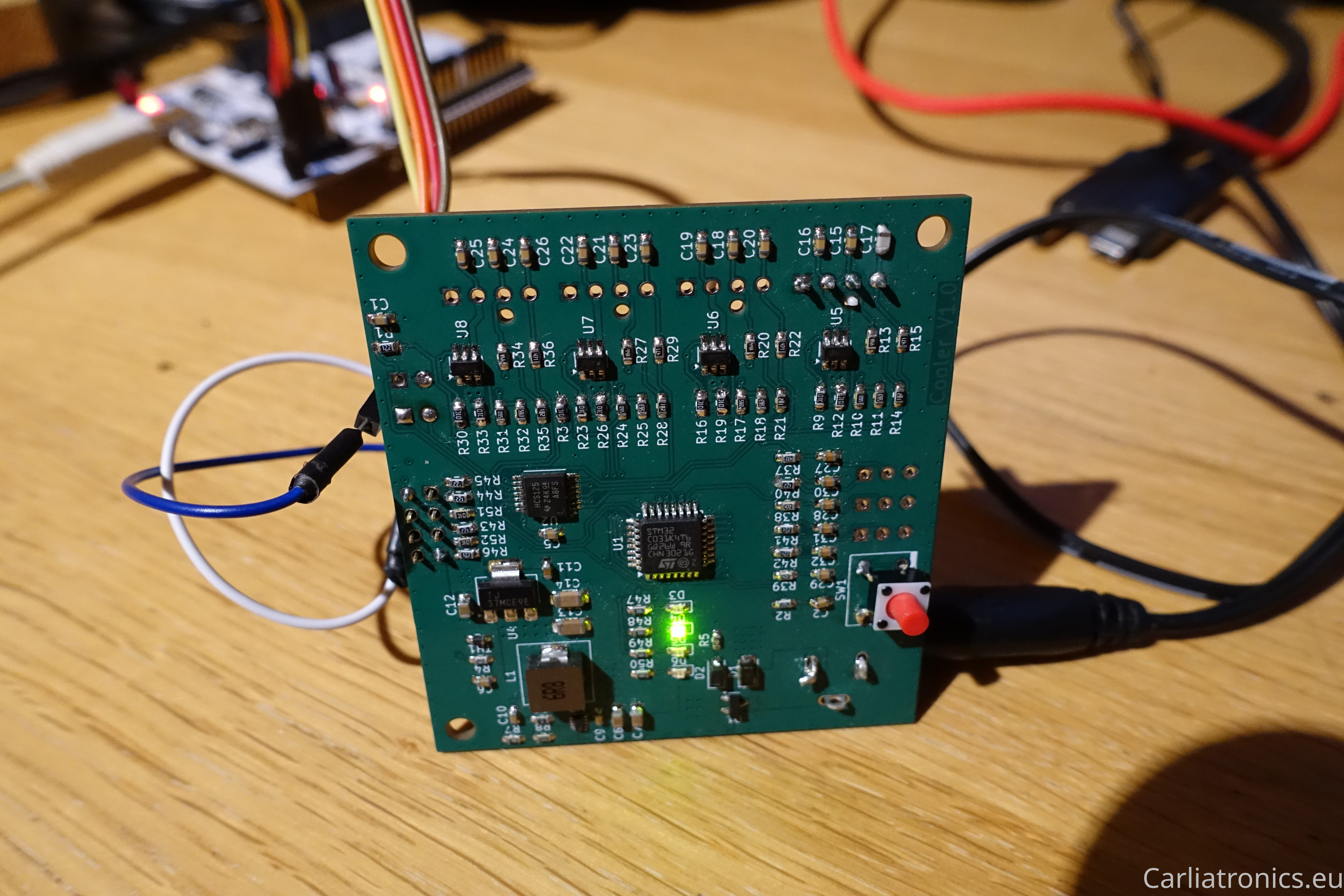 An image of a PCB with lit LED